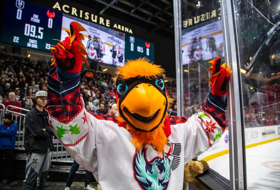 Fuego, the Coachella Valley Firebirds mascot, cheers for the team during the second period of their game at Acrisure Arena in Palm Desert, Calif., Friday, Dec. 23, 2022. 