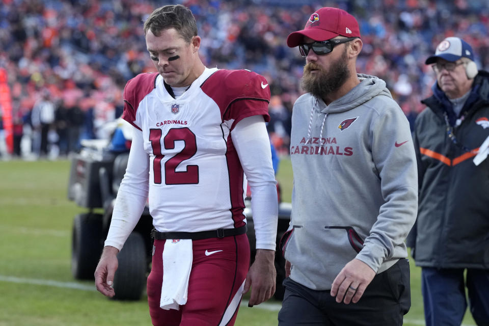 Arizona Cardinals quarterback Colt McCoy (12) leaves the game after a hit during the second half of an NFL football game against the Denver Broncos, Sunday, Dec. 18, 2022, in Denver. (AP Photo/David Zalubowski)