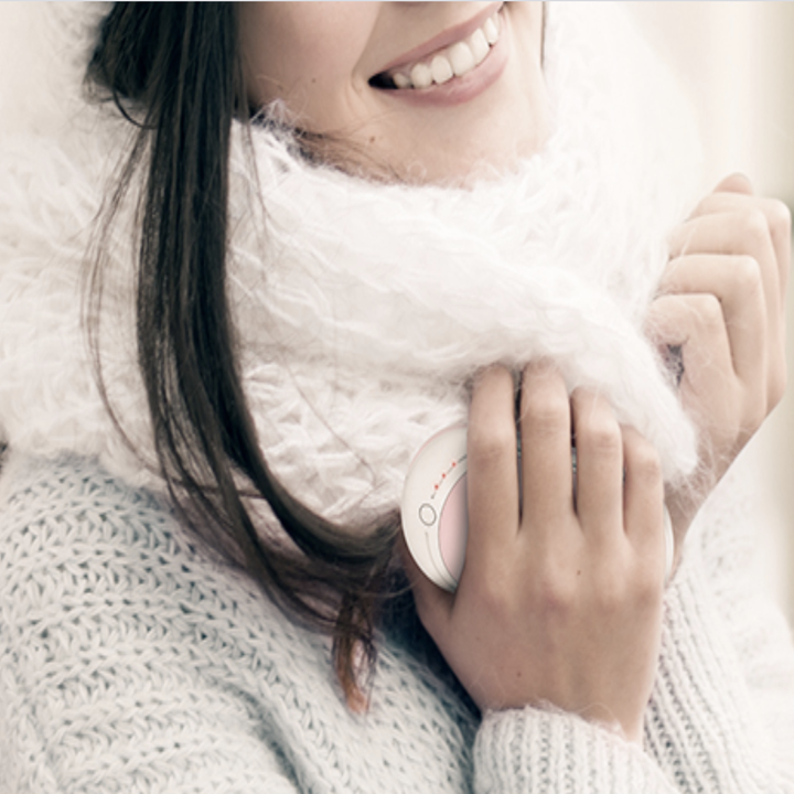 A model with a pink warmer in their hand 