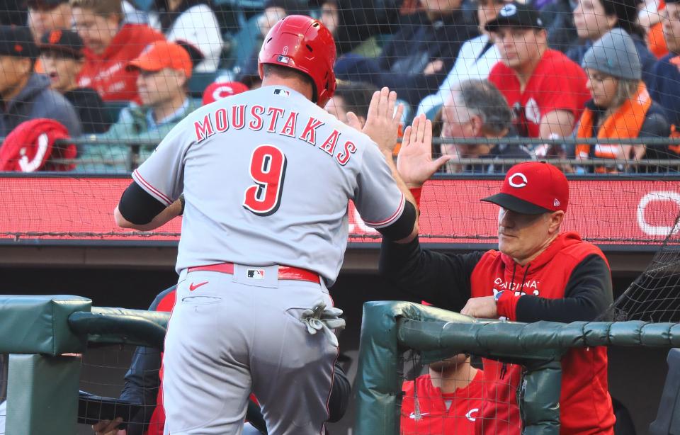 Jun 24, 2022; San Francisco, California, USA; Cincinnati Reds designated hitter Mike Moustakas (9) high fives the dugout after scoring a run against the San Francisco Giants during the second inning at Oracle Park. Mandatory Credit: Kelley L Cox-USA TODAY Sports