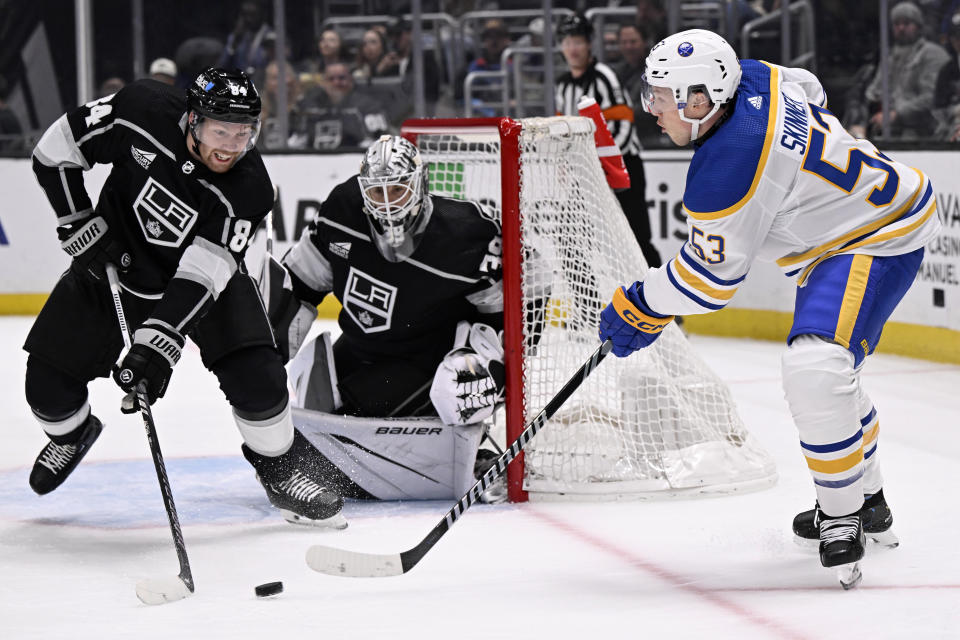 Buffalo Sabres left wing Jeff Skinner (53) passes the puck asLos Angeles Kings defenseman Vladislav Gavrikov (84) and goaltender Cam Talbot, center, defend during the first period of an NHL hockey game in Los Angeles, Wednesday, Jan. 24, 2024. (AP Photo/Alex Gallardo)