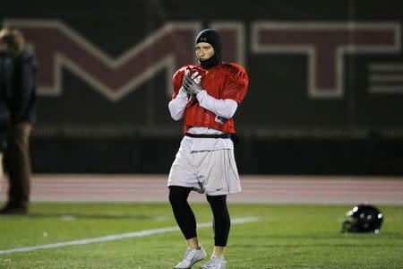 Running back and wide receiver Brad Goldsberry takes the field during a Massachusetts Institute of Technology (MIT) Engineers football team practice in Cambridge, Massachusetts November 13, 2014. REUTERS/Brian Snyder