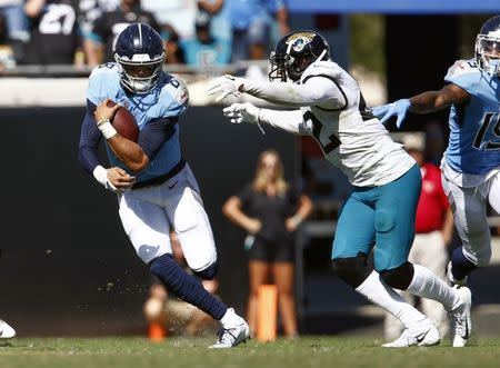 Sep 23, 2018; Jacksonville, FL, USA; Jacksonville Jaguars defensive back Barry Church (42) chases Tennessee Titans quarterback Marcus Mariota (8) during the second half at TIAA Bank Field. Mandatory Credit: Reinhold Matay-USA TODAY Sports