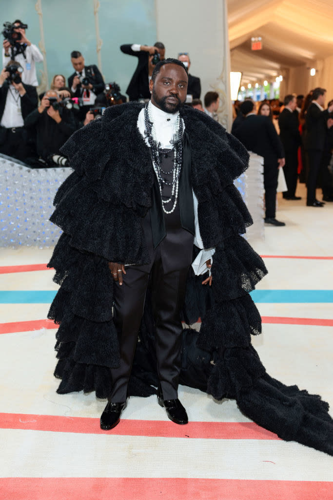 Brian Tyree Henry attends The 2023 Met Gala in a long black fur coat