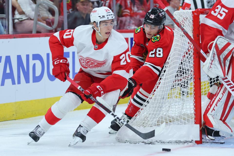 Red Wings forward Albert Johansson skates with the puck against the Blackhawks' Colton Dach during the first period of preseason game on Tuesday, Oct. 3, 2023, in Chicago.