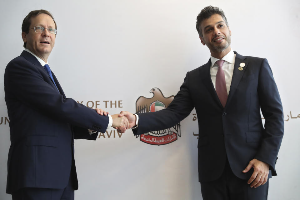 Israel's President Isaac Herzog, left, shakes hands with United Arab Emirates Ambassador to Israel Mohamed Al Khaja during the opening ceremony for the new UAE Embassy in Tel Aviv, Israel, Wednesday, July 14, 2021. (AP Photo/Ariel Schalit)