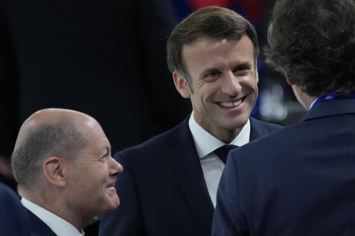 French President Emmanuel Macron, center, and German Chancellor Olaf Scholz, left, smile at the start of the session during the NATO summit Thursday, June 30, 2022 in Madrid. North Atlantic Treaty Organization heads of state are meeting for the final day of a NATO summit in Madrid on Thursday. (AP Photo/Christophe Ena, Pool)