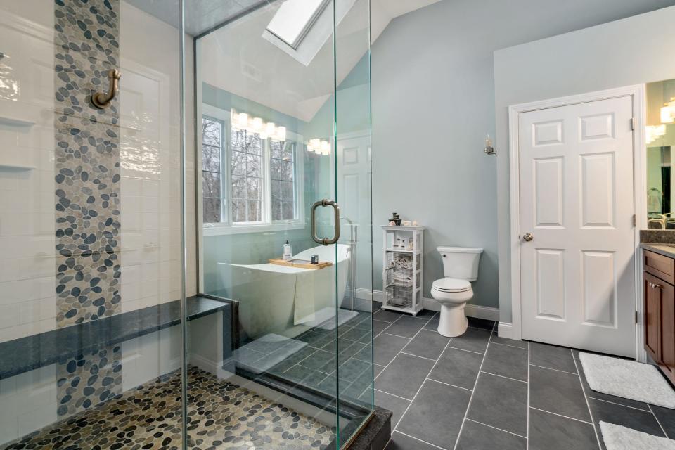 The master bedroom includes a spalike bath featuring a soaker tub and steam shower.