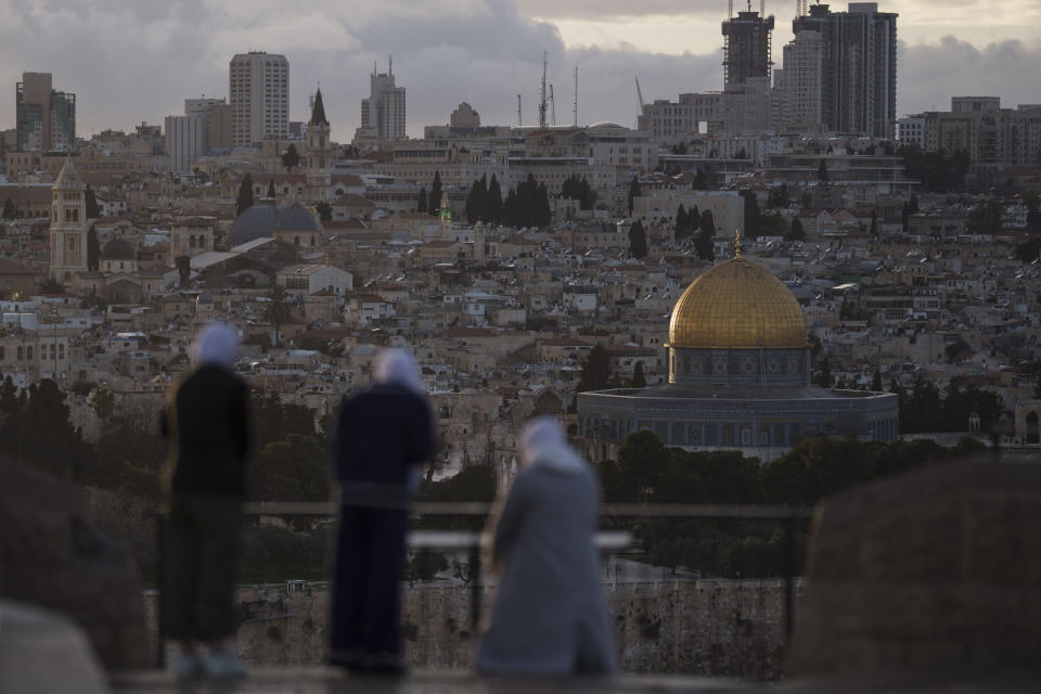 FILE - Muslim women visit the Mount of Olives, overlooking the Dome of the Rock at the Al Aqsa Mosque compound in the Old City of Jerusalem, Thursday, March 7, 2024. Restrictions put in place amid the Israel-Hamas war have left many Palestinians concerned they might not be able to pray at the mosque, which is revered by Muslims. (AP Photo/Leo Correa, File)