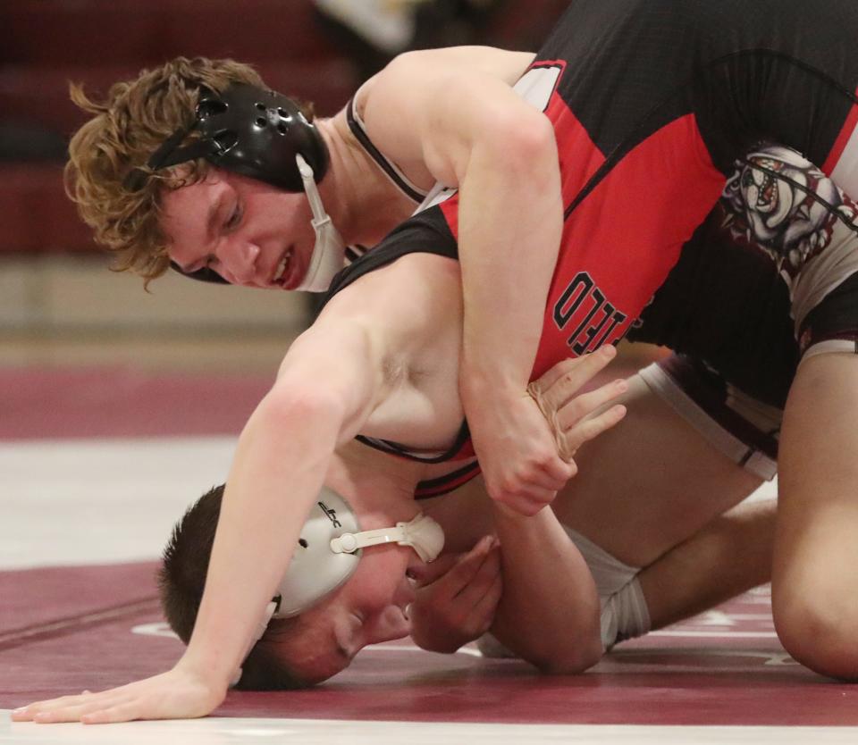 Woodridge's A.J. Rickenbacher drives Springfield's Coby Watkins to the mat in their 138-pound match Thursday. [Mike Cardew/Beacon Journal]