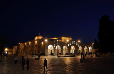 Visitors walk past al-Aqsa Mosque at night on the compound known to Muslims as al-Haram al-Sharif and to Jews as Temple Mount, in Jerusalem's Old City, May 9, 2017. REUTERS/Ammar Awad