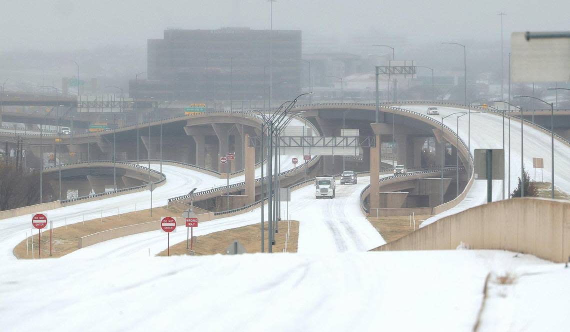 Vehicles slowly drive on Interstate 30 near downtown Fort Worth on Tuesday, January 31, 2022. Winter storm and ice storm warnings are extended through 6 a.m. Thursday and freezing rain is expected most of Tuesday and Wednesday, officials said.