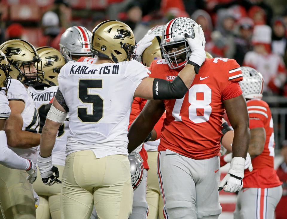 Purdue Boilermakers defensive end George Karlaftis (5) and Ohio State Buckeyes offensive tackle Nicholas Petit-Frere (78) say their goodbyes as the horn sounds to end Saturday's NCAA Division I football game at Ohio Stadium in Columbus, Oh., on November 13, 2021. Ohio State won the game 59-31.