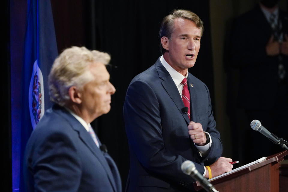 FILE - In this Sept. 16, 2021, file photo Republican gubernatorial candidate Glenn Youngkin, right, gestures as Democratic gubernatorial candidate and former governor Terry McAuliffe, left, looks on during a debate at the Appalachian School of Law in Grundy, Va.McAuliffe has generally led in public polling, but recent surveys have suggested his lead is tightening. His race against Glenn Youngkin is one of the country’s most competitive and closely watched political matchups of the year. (AP Photo/Steve Helber, File)