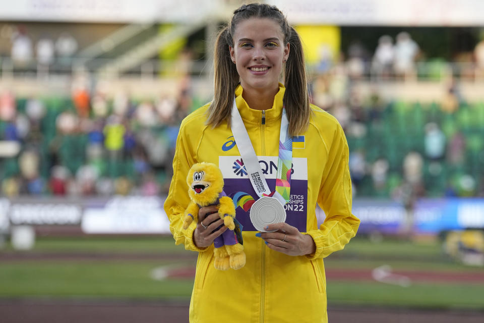 Silver medalist Yaroslava Mahuchikh, of Ukraine, poses on the podium after the women's high jump final at the World Athletics Championships on Tuesday, July 19, 2022, in Eugene, Ore. (AP Photo/Gregory Bull)