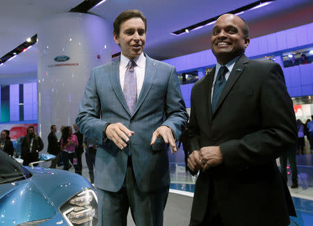 Ford CEO Mark Fields (L) and Raj Nair, Group VP Global Product Development, speak next to a Ford GT during the second press day of the North American International Auto Show in Detroit, Michigan January 13, 2015. REUTERS/Rebecca Cook/File Photo