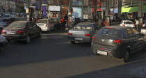 People fill their cars at a gas station in Tehran, Iran Wednesday, Oct. 27, 2021. Iran's President Ebrahim Raisi said Wednesday that a cyberattack which paralyzed every gas station in the Islamic Republic was designed to get "people angry by creating disorder and disruption." Long lines snaked around the pumps a day after the incident began as some stations began selling fuel again although at higher, unsubsidized prices. (AP Photo/Vahid Salemi)