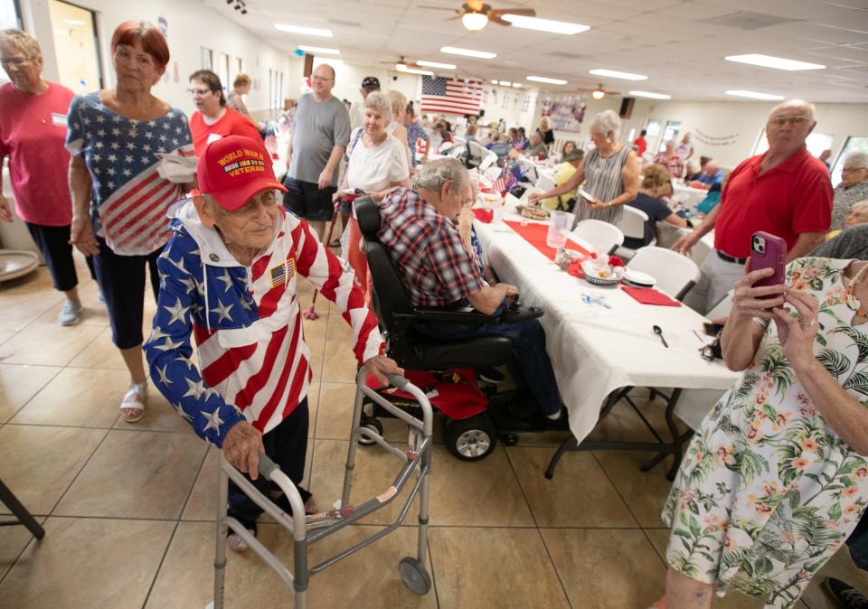 Howard Mautner heads to the cake table on April 27. The World War II veteran was honored at his 100th birthday party.