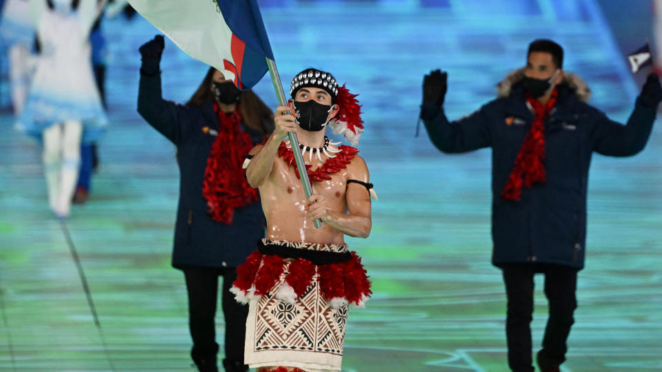 American Samoa's flag bearer Nathan Crumpton stole the show at the opening ceremony of the Olympics. (Photo by MANAN VATSYAYANA/AFP via Getty Images)