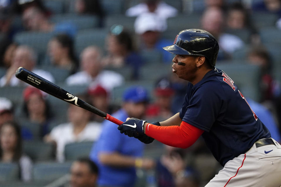 Boston Red Sox's Rafael Devers drives in a run with a base hit during the third inning of the team's baseball game against the Atlanta Braves on Tuesday, June 15, 2021, in Atlanta. (AP Photo/John Bazemore)