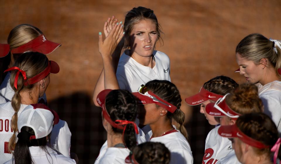 Alabama pitcher Montana Fouts squints into the sun as she gives high fives to teammates at the end of an inning in the game with Mississippi State at Rhoads Stadium Thursday, April 14, 2022. Gary Cosby Jr./Tuscaloosa News  