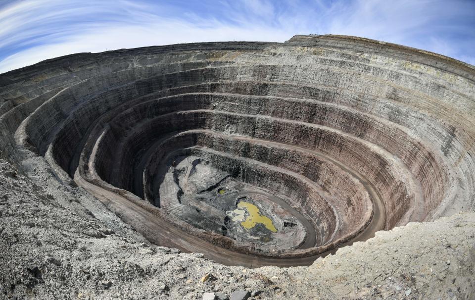 A view of Nyurbinsky diamond mining pit of Nakyn diamond ore field, some 340 kms North-East from the town of Mirny on July 2, 2019. - The Nyurbinsky diamond mining pit has now depth of 375 meters, with a project depth of 570 meters, having 4,6 carats of diamonds per one tonne of kimberlite ore in this pipe. Russian Alrosa gets its diamonds in the permafrost abyssal holes dug with explosives in the permanently frozen ground of Yakutia, an isolated region in East Siberia, the home to the huge diamond deposits that ensure Russia's supremacy in world production. (Photo by Alexander NEMENOV / AFP)        (Photo credit should read ALEXANDER NEMENOV/AFP via Getty Images)