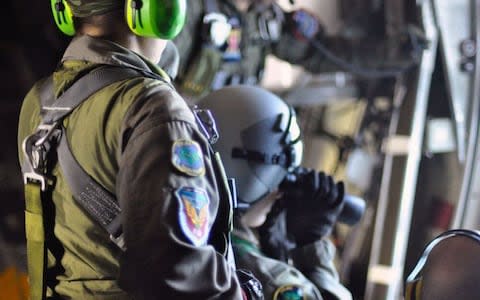 Argentinian Navy personnel on board a C130 searching for missing submarine ARA San Juan - Credit:  Argentinian Navy