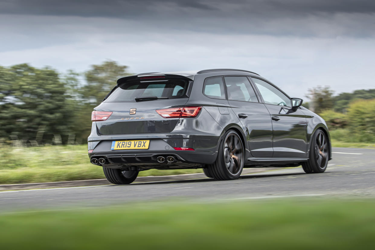 Quad exhaust pipes are visible at the rear of the car