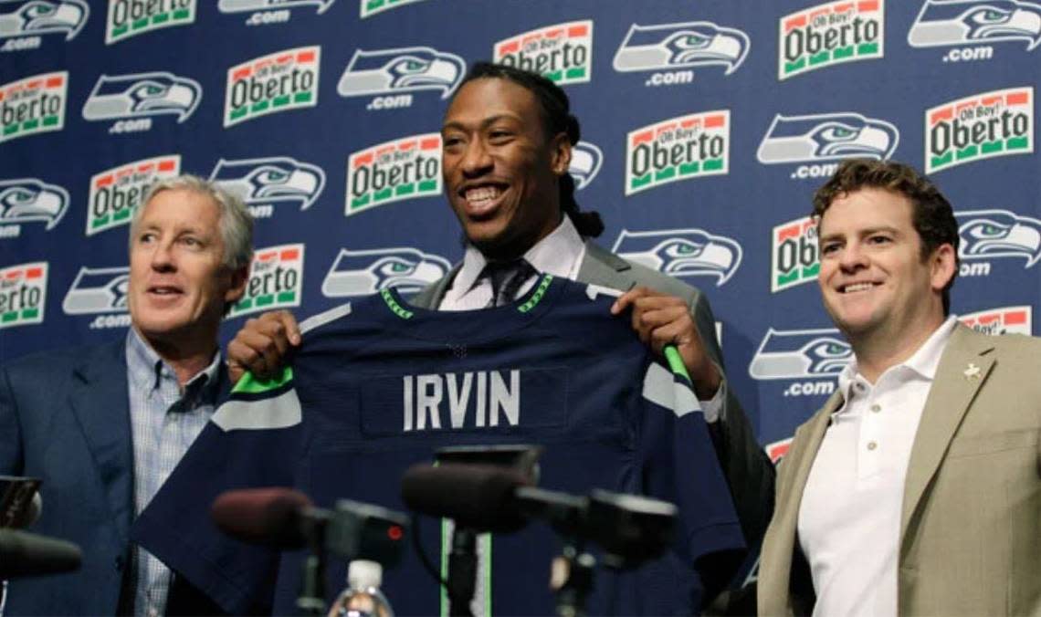 Coach Pete Carroll (left), general manager John Schneider (right) and the Seahawks got roundly criticized for their 2012 NFL draft. That included picking lightly regarded pass rusher Bruce Irvin (center) first, as the 15th-overall pick 10 years ago. Within 22 months, Irvin was a key member of Seattle’s Super Bowl-winning defense.