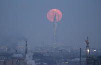 <p>A full moon is seen behind the business tower Lakhta Center, which is under construction in St. Petersburg, Russia, Jan. 31, 2018. (Photo: Anton Vaganov/Reuters) </p>