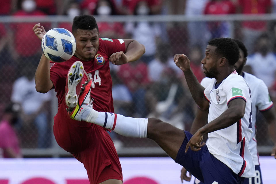 Panama's Rolando Blackburn, left, and United States´ Kellyn Acosta fight for the ball during a qualifying soccer match for the FIFA World Cup Qatar 2022 at Rommel Fernandez stadium, Panama city, Panama, Sunday, Oct. 10, 2021. (AP Photo/Arnulfo Franco)