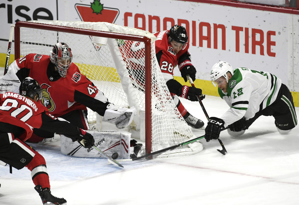 Ottawa Senators goaltender Craig Anderson (41) makes a pad save against a wraparound attempt by Dallas Stars center Radek Faksa (12) during the first period of an NHL hockey game Sunday, Feb. 16, 2020, in Ottawa, Ontario. (Justin Tang/The Canadian Press via AP)