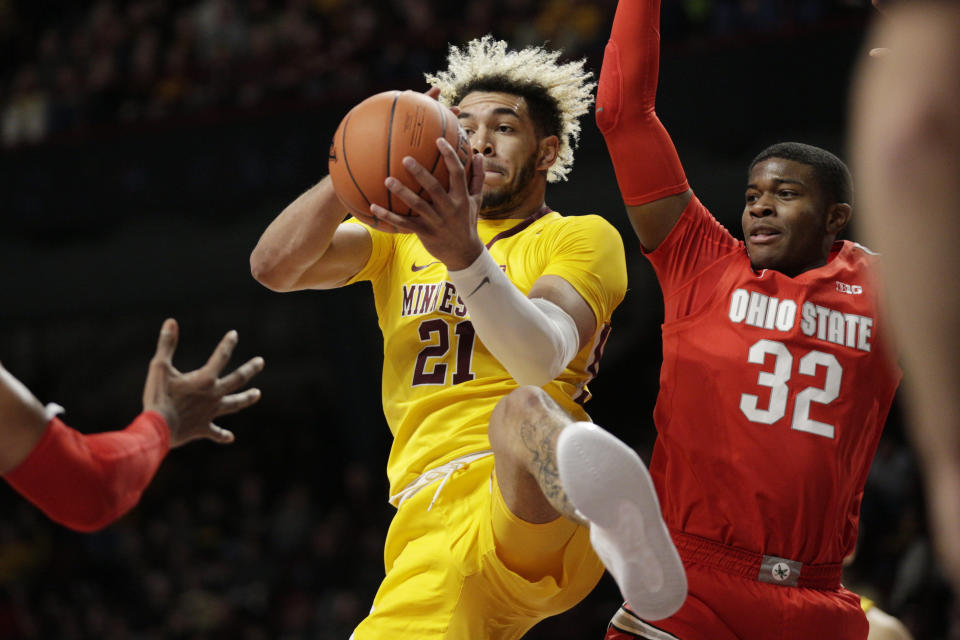 Minnesota forward Jarvis Omersa (21) grabs a rebound in front of Ohio State guard E.J. Liddell (32) in the first half of an NCAA college basketball game Sunday, Dec. 15, 2019, in Minneapolis. (AP Photo/Andy Clayton-King)