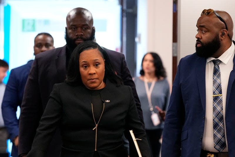 Fulton County District Attorney Fani Willis, center, arrives to the Fulton county courthouse, Tuesday, July 11, 2023, in Atlanta. A grand jury being seated Tuesday in Atlanta will likely consider whether criminal charges are appropriate for former President Donald Trump or his Republican allies for their efforts to overturn his 2020 election loss in Georgia. - Photo: Brynn Anderson (AP)
