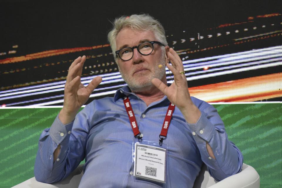 Michael Henderson, co-founder of Moon World Resorts discusses his brainchild, a proposal to build a $5 billion moon-shaped resort, at the Arabian Travel Market, May 4, 2023, in Dubai, United Arab Emirates. Canadian entrepreneur Henderson envisions building a 274-meter (900-foot) replica of the moon atop a 30-meter (100-foot) building in Dubai, already home to the world's tallest building and other architectural wonders. (AP Photo/Nick El Hajj)