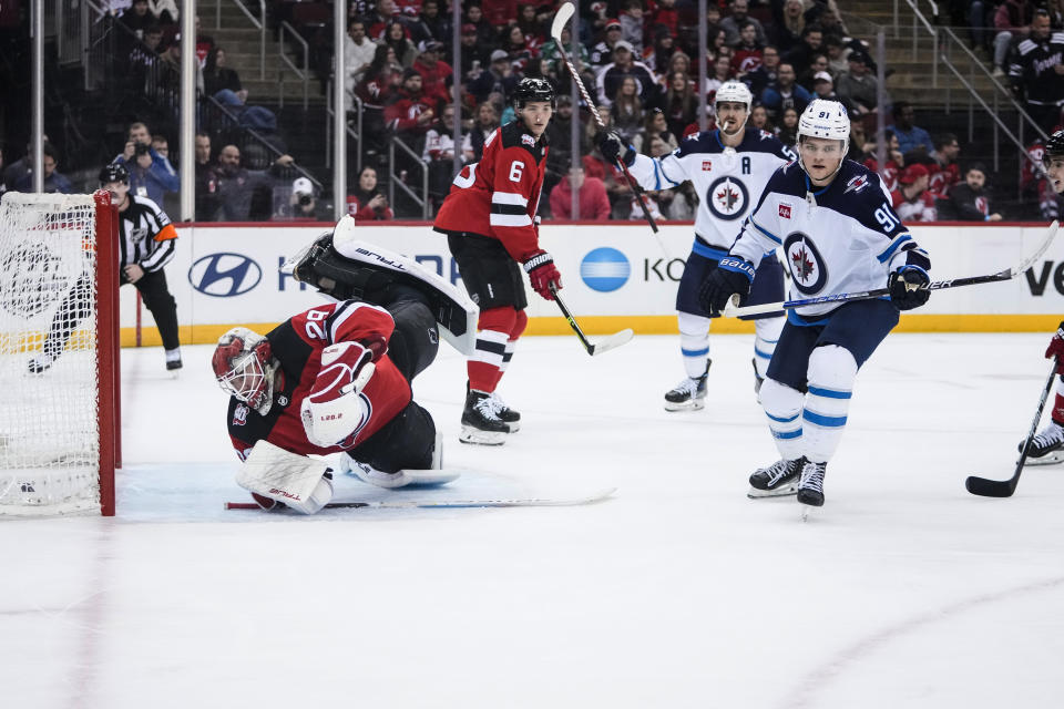 Winnipeg Jets' Cole Perfetti (91) turns after scoring a goal against New Jersey Devils goaltender Mackenzie Blackwood (29) during the first period of an NHL hockey game Sunday, Feb. 19, 2023, in Newark, N.J. (AP Photo/Frank Franklin II)
