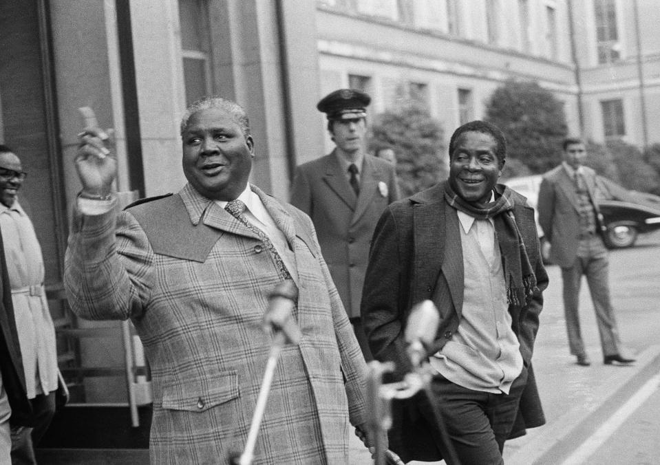 FILE - In this Wednesday, Nov. 10, 1976 file photo, leaders of the Black National Front Joshua Nkomo, left, and Robert Mugabe make a no progress statement after their informal meeting with British chairman Ivor Richard at the Palais of Nations, Geneva, Switzerland. On Friday, Sept. 6, 2019, Zimbabwe President Emmerson Mnangagwa said his predecessor Mugabe, age 95, has died. (AP Photo/Dieter Endlicher, file)