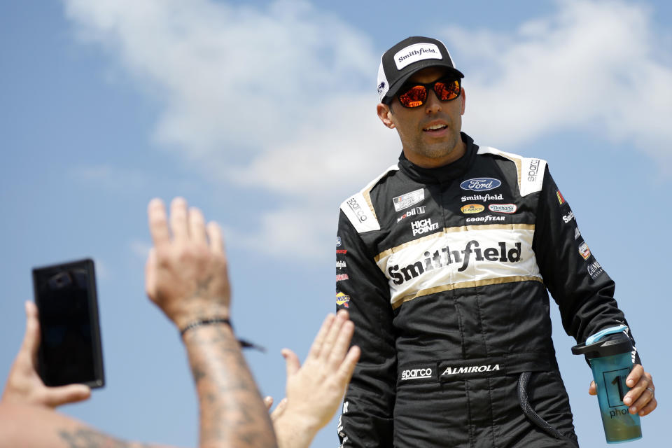 TALLADEGA, ALABAMA - OCTOBER 01: Aric Almirola, driver of the #10 Smithfield Ford, greets fans as he walks onstage during driver intros prior to  the NASCAR Cup Series YellaWood 500 at Talladega Superspeedway on October 01, 2023 in Talladega, Alabama. (Photo by Sean Gardner/Getty Images)
