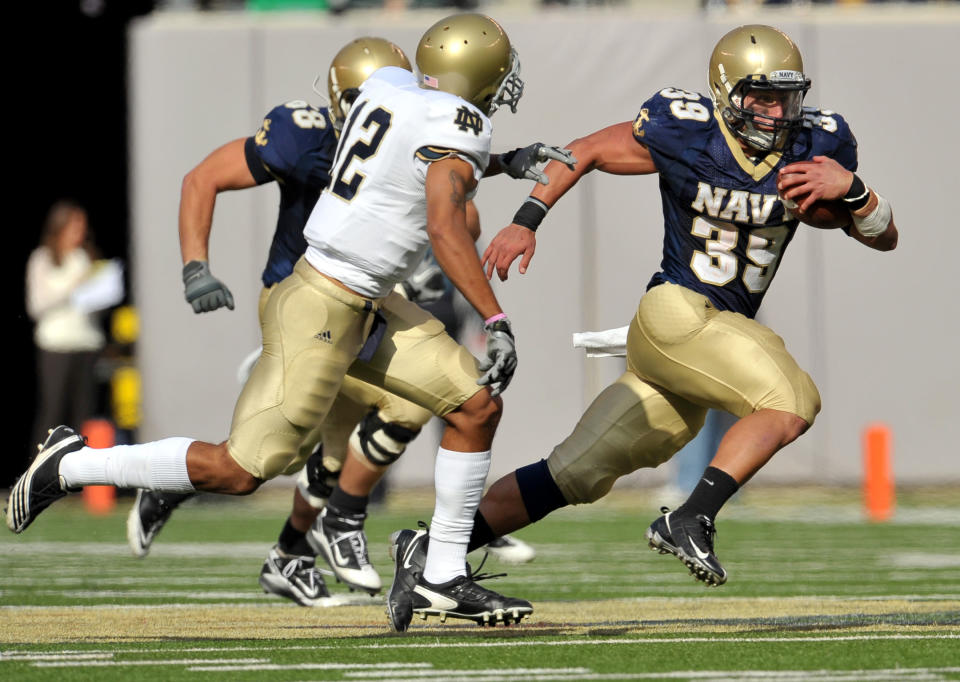 Oct. 23, 2010; East Rutherford, N.J.; Navy Midshipmen fullback Alexander Teich (39) runs the ball as Notre Dame Fighting Irish cornerback Robert Blanton (12) attempts to tackle in the third quarter at New Meadowlands Stadium. Navy won 35-17. Matt Cashore-USA TODAY Sports