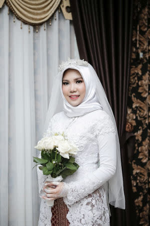 A wedding photo of the bride of a Lion Air flight JT610 victim, who carried on the celebration despite the absence of the groom, in Bangka, Bangka Belitong Province, Indonesia November 11, 2018 in this picture obtained from social media on November 16, 2018. LALA INDRA PERMANA/via REUTERS