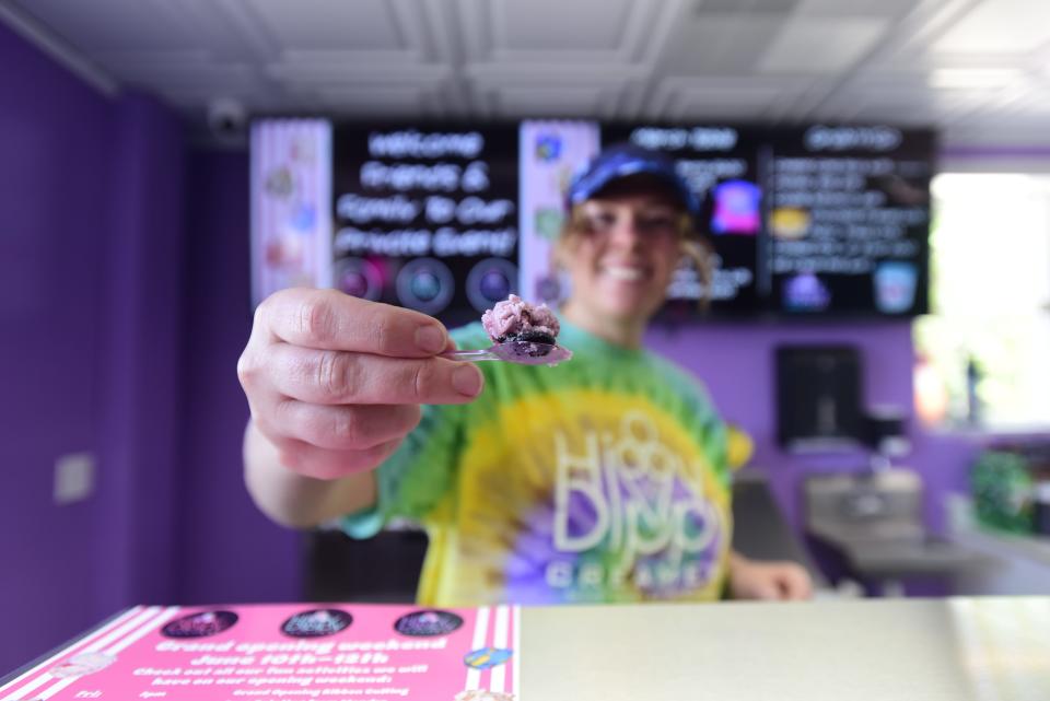 Store employee Alicia Martinez scoops a serving of a non-diary option of ice cream to a customer at Hippy Dippy Creamery on 312 East Huron Blvd., across from Marysville High School, on Thursday, June 2, 2022.