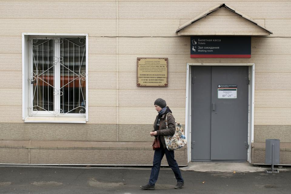 A woman walks past the Memorial plaque in memory of North Korean leader Kim Jong Il's visit to Russia in 2002, at the Okeanskaya railway station where North Korean leader Kim Jong Un is expected to make his first stop before his summit with Russian President Vladimir Putin, in the border at Russia's Far East, Tuesday, April 23, 2019.North Korea on Tuesday confirmed that leader Kim Jong Un will soon visit Russia to meet with Putin in a rare summit. (AP Photo/Alexander Khitrov)