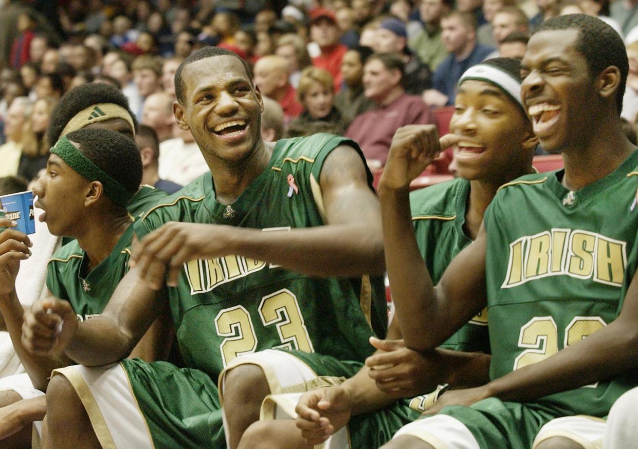 St. Vincent-St Mary High School basketball phenomenon LeBron James (L)
laughs with his teammates Marcus Johnson (C) and Willie McGee (R)
during the fourth quarter against Kettering Alter High School at
University of Dayton Arena in Dayton, Ohio, February 16, 2003. St.
Vincent-St Mary High School won 73-40. REUTERS/ John Sommers II

JPSII