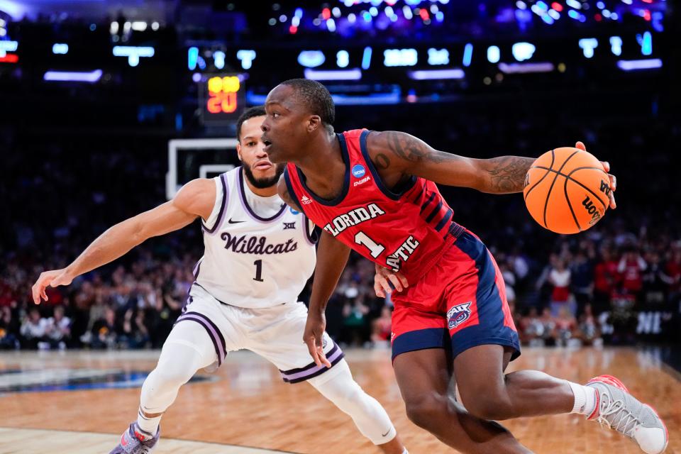 Florida Atlantic Owls guard Johnell Davis (1) drives to the basket as Kansas State Wildcats guard Markquis Nowell (1) defends during the first half of an NCAA Tournament East Regional final at Madison Square Garden.