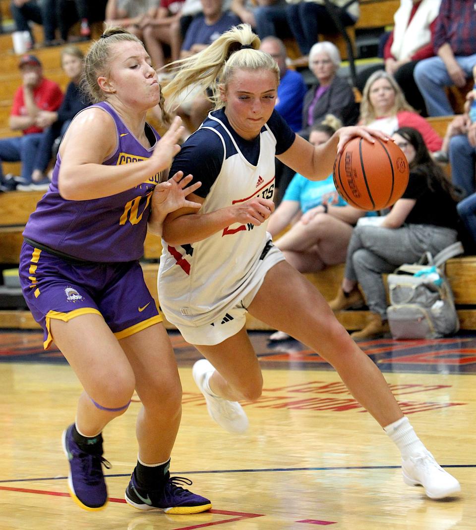 Bedford North Lawrence's Chloe Spreen (2) drives past Scottsburg's Carrie Hiler (10) during a scrimmage Thursday, Oct. 26, 2023.