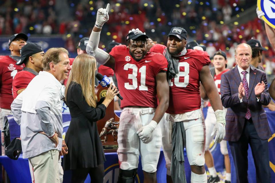 Alabama linebacker Will Anderson Jr. (31) and defensive lineman Phidarian Mathis (48) celebrate after the team's defeat of Georgia in the SEC championship game at Mercedes-Benz Stadium.