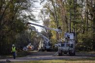 Utility workers repair power lines in the aftermath from Tuesday's severe weather, Wednesday, Nov. 30, 2022, in Eutaw, Ala. (AP Photo/Vasha Hunt)