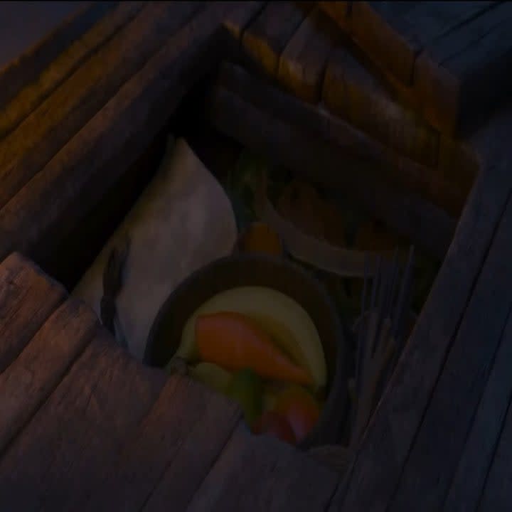 Moana's supplies in her boat, including a carrot and sticks that resemble Olaf's