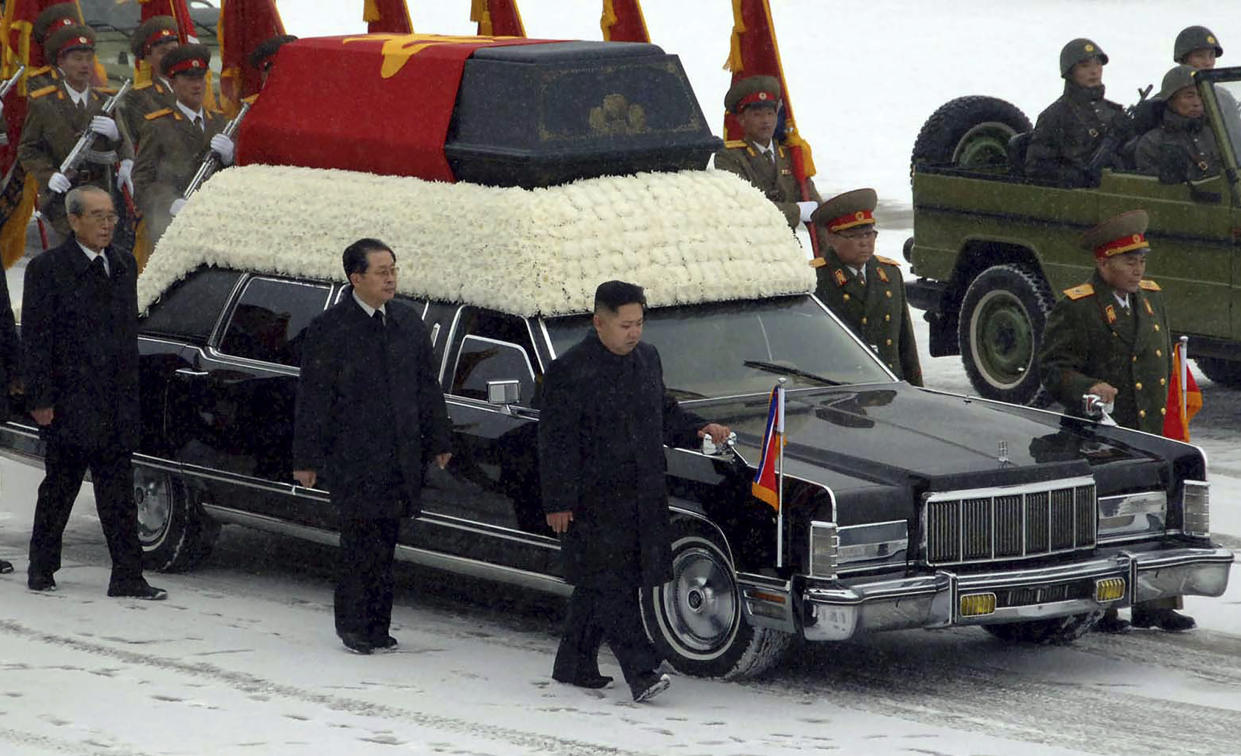 FILE - In this photo released by the Korean Central News Agency and distributed in Tokyo by the Korea News Service, North Korea's next leader Kim Jong Un, center, walks beside the hearse carrying the body of his late father and North Korean leader Kim Jong Il during the funeral procession in Pyongyang, North Korea on Dec. 28, 2011. Escorting Kim Jong Un are, Jang Song Thaek, Kim Jong Il's brother-in-law and vice chairman of the National Defense Commission, second from left, top propaganda official Kim Ki Nam, left, and two military officers, Ri Yong Ho, right, vice marshal of the Korean People's Army and People's Armed Forces Minister Kim Yong Chun. It's been 10 years since Kim Jong Un took power in North Korea after his father suddenly died of a heart attack. The content of this image is as provided and cannot be independently verified. (AP Photo/Korean Central News Agency via Korea News Service, File)