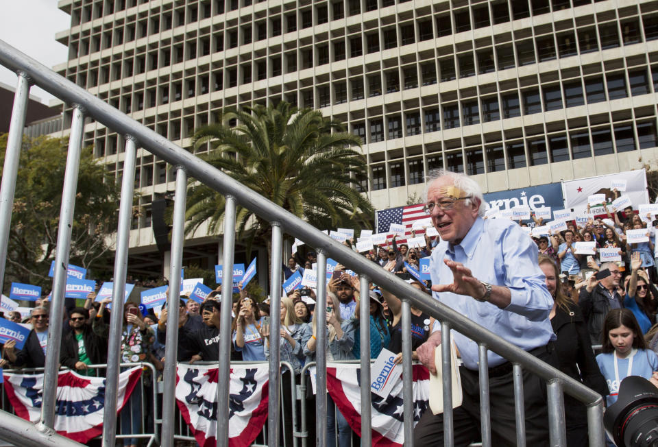 Democratic presidential candidate Sen. Bernie Sanders climbs to the podium as he arrives at a rally at Grand Park in Los Angeles Saturday, March 23, 2019. The Vermont senator made a notable, second-place finish in California's 2016 presidential primary when he won 27 of 58 counties. (AP Photo/Damian Dovarganes)